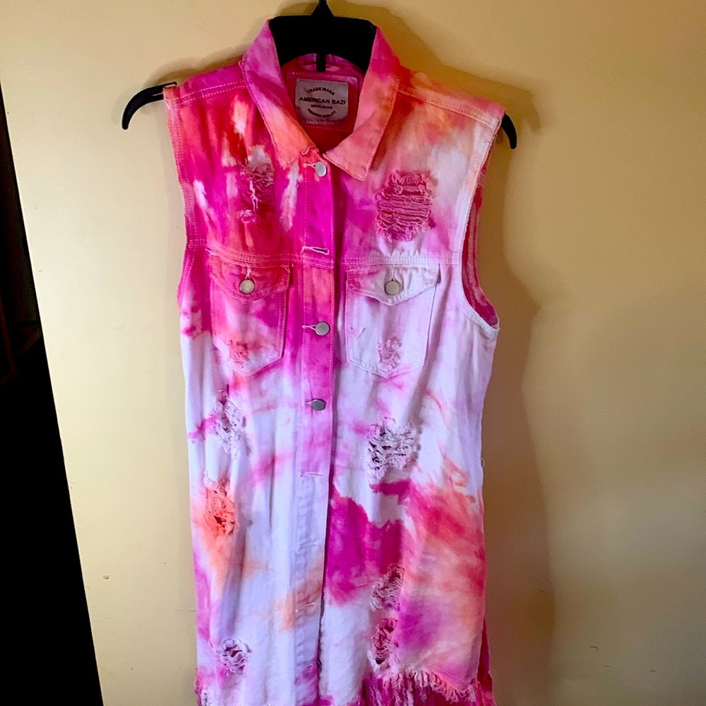 Colorful tie dyed, distressed, retro, sleeveless denim jacket with pockets.